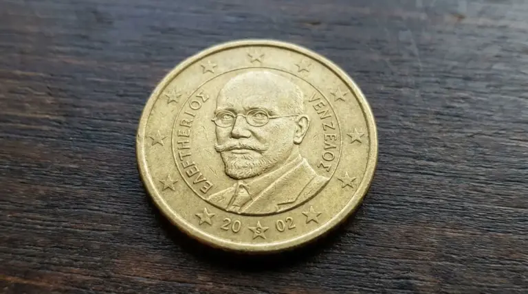 Moneta da 50 centesimi euro della Grecia 2002 con ritratto, appoggiata su superficie in legno